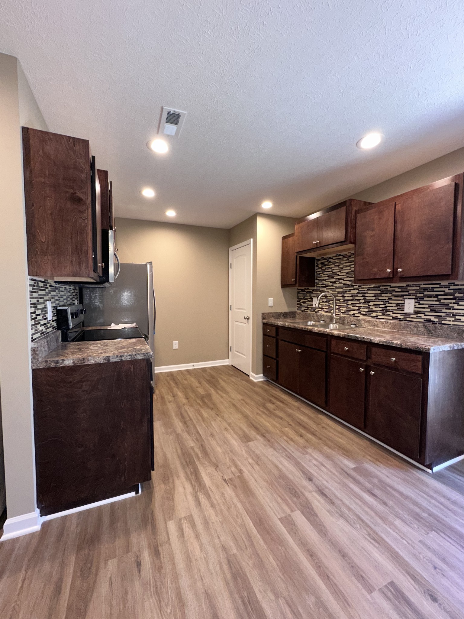 517 Weaver Street, Unit 4 Tullahoma, TN 37388 - Photo 10 of 22 a kitchen with stainless steel appliances granite countertop a stove a sink and a refrigerator