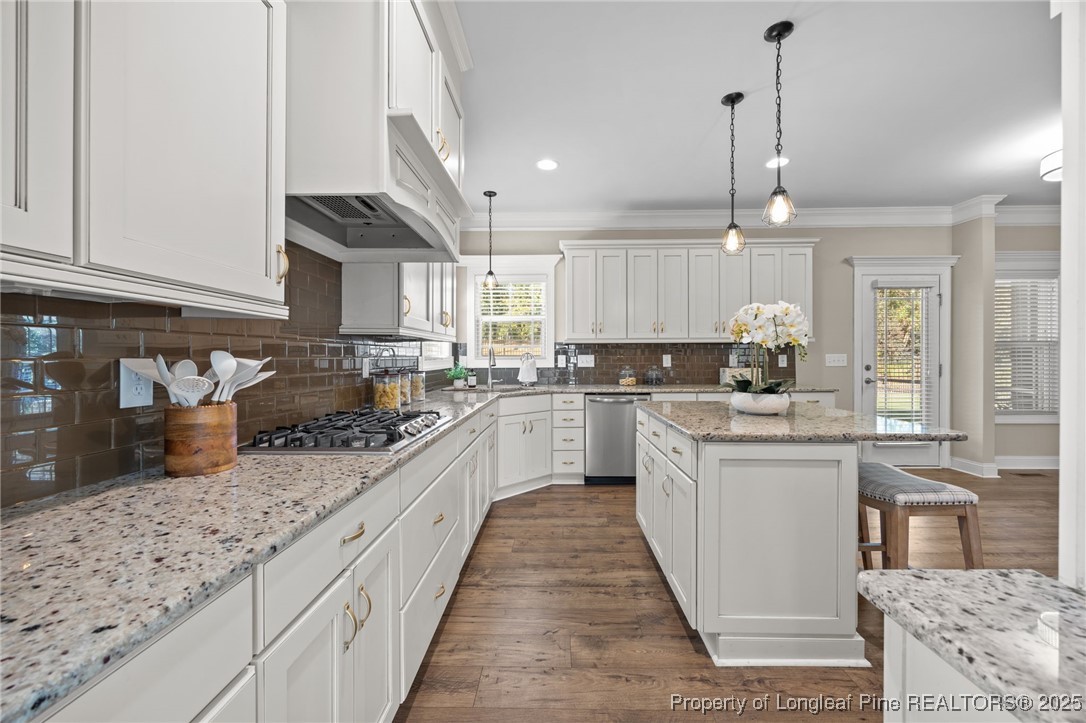 2904 Hampton Ridge Road Fayetteville, NC 28311 - Photo 14 of 50 a kitchen with stainless steel appliances granite countertop a sink a stove and cabinets