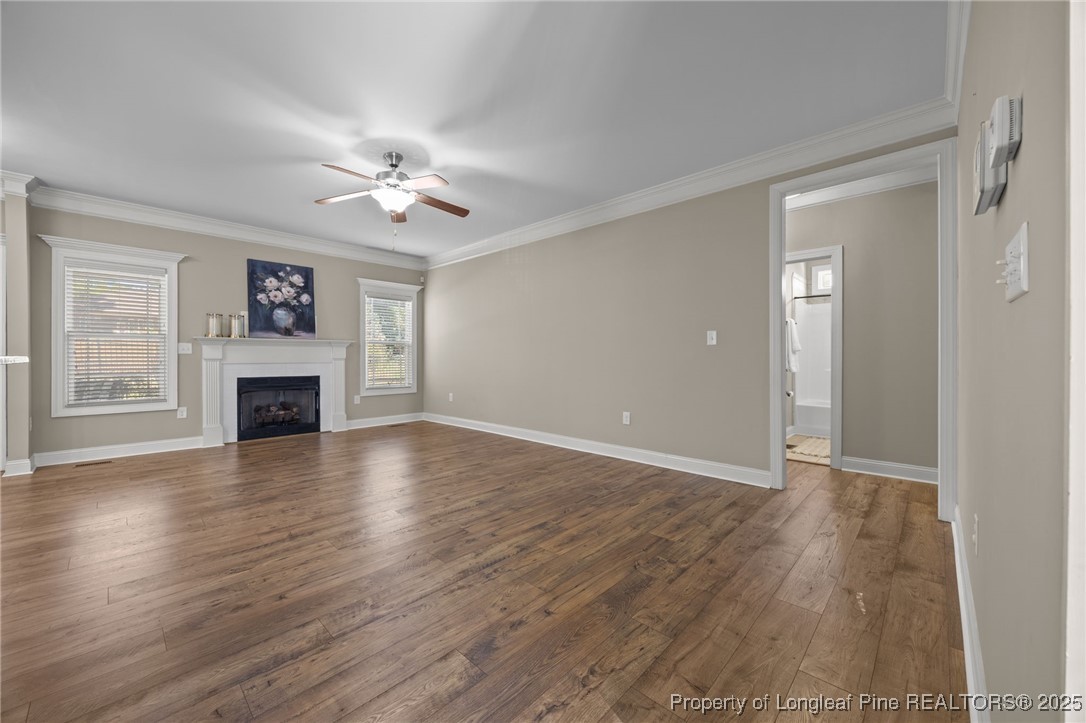 2904 Hampton Ridge Road Fayetteville, NC 28311 - Photo 24 of 50 an empty room with wooden floor fireplace and windows