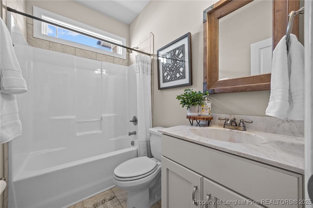 2904 Hampton Ridge Road Fayetteville, NC 28311 - Photo 26 of 50 a bathroom with a sink a mirror a toilet and a bathtub