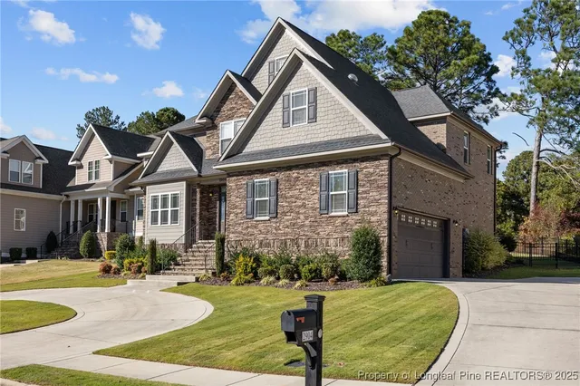 a front view of a house with yard porch and outdoor seating