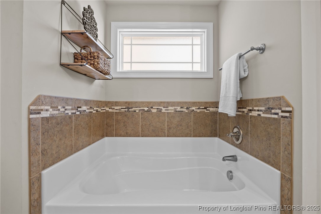 2904 Hampton Ridge Road Fayetteville, NC 28311 - Photo 32 of 50 a bathroom with bathtub and window