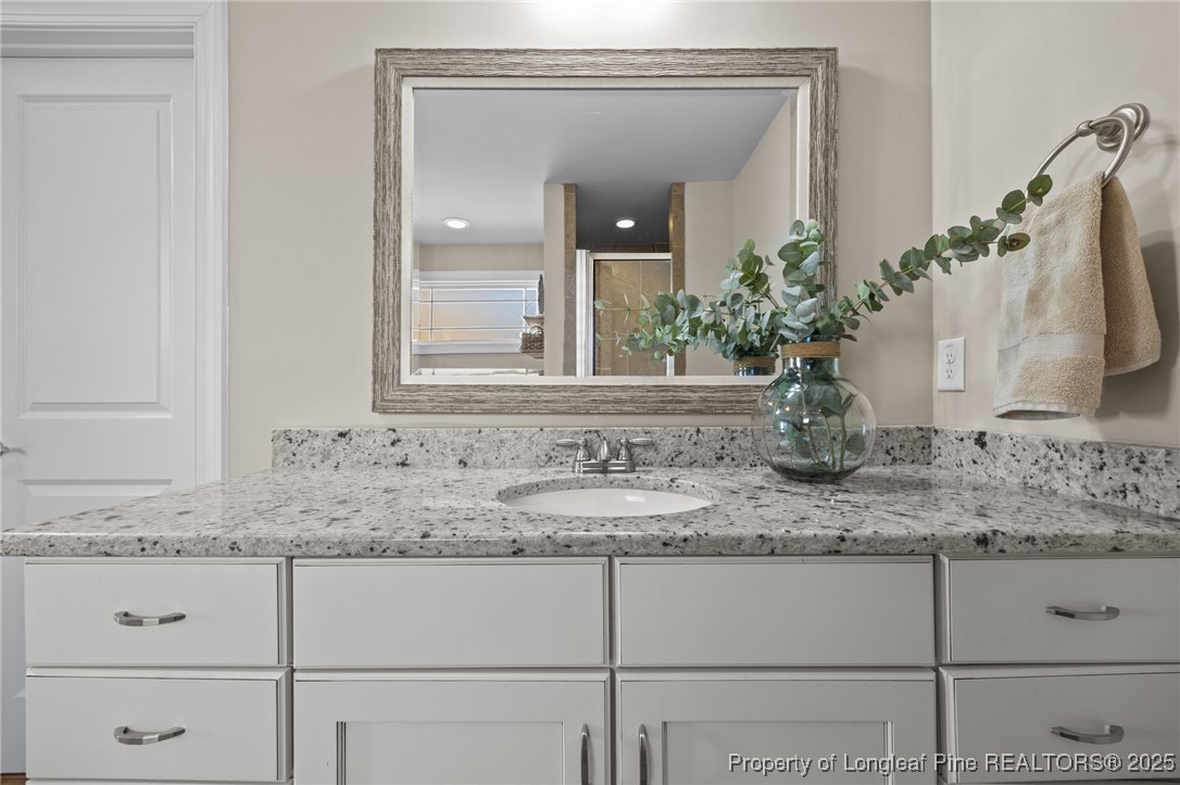 2904 Hampton Ridge Road Fayetteville, NC 28311 - Photo 33 of 50 a bathroom with sink mirror and vanity