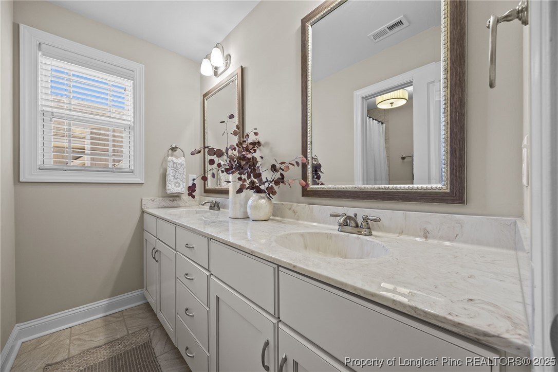 2904 Hampton Ridge Road Fayetteville, NC 28311 - Photo 35 of 50 a bathroom with double sink and a mirror