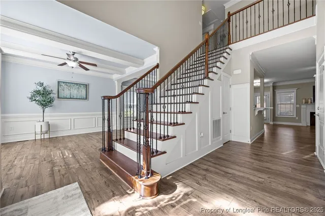 a kitchen with a stove a sink dishwasher a kitchen island with wooden cabinets and floor