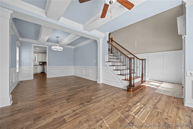 a kitchen with granite countertop a sink and white cabinets