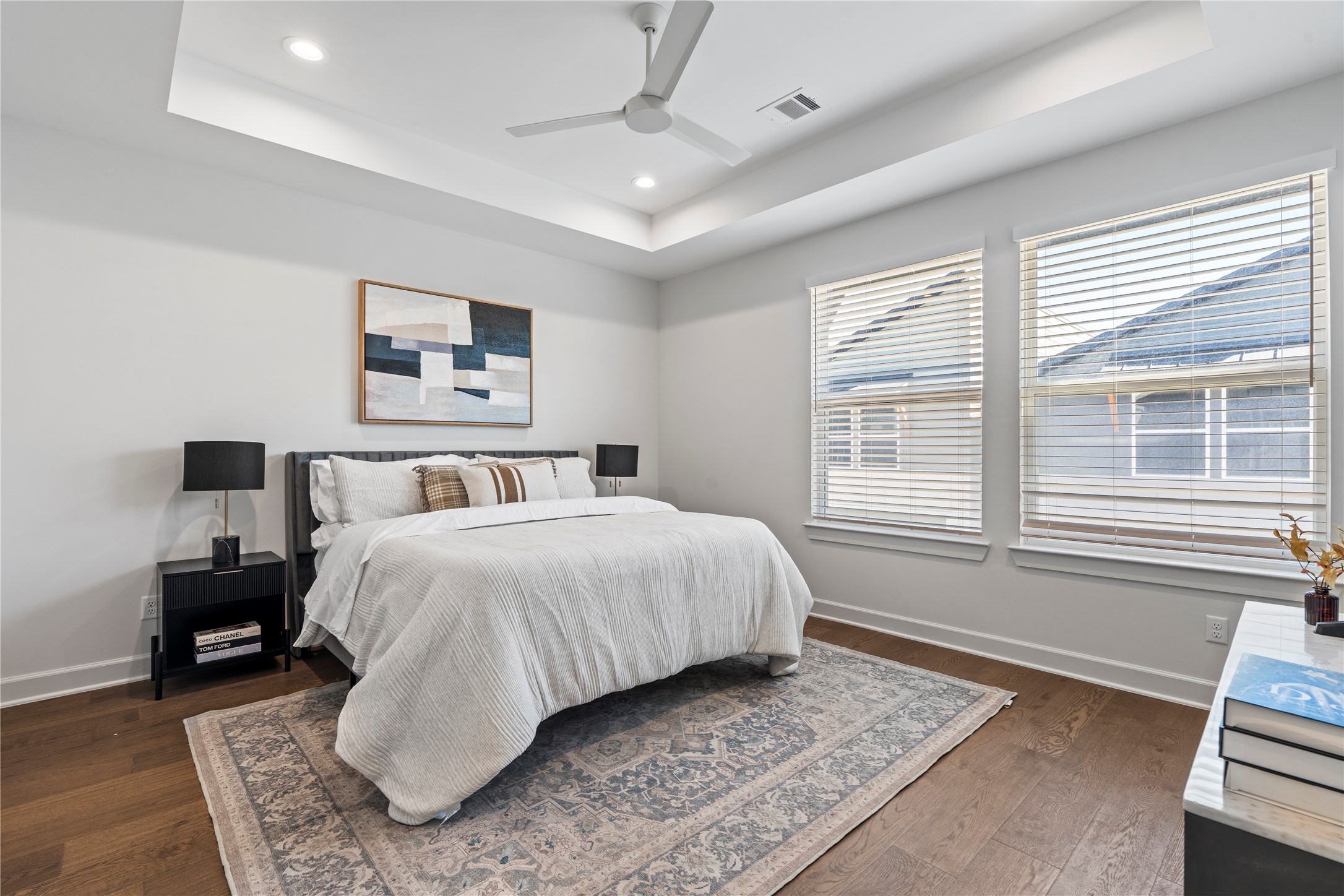 4708 Moving Meadows Houston, TX 77018 - Photo 27 of 40 This spacious primary bedroom features a tray ceiling and wide-plank floors for a clean, modern feel. The generous layout gives you flexibility in how you arrange the room, whether you prefer a simple setup or a more styled retreat