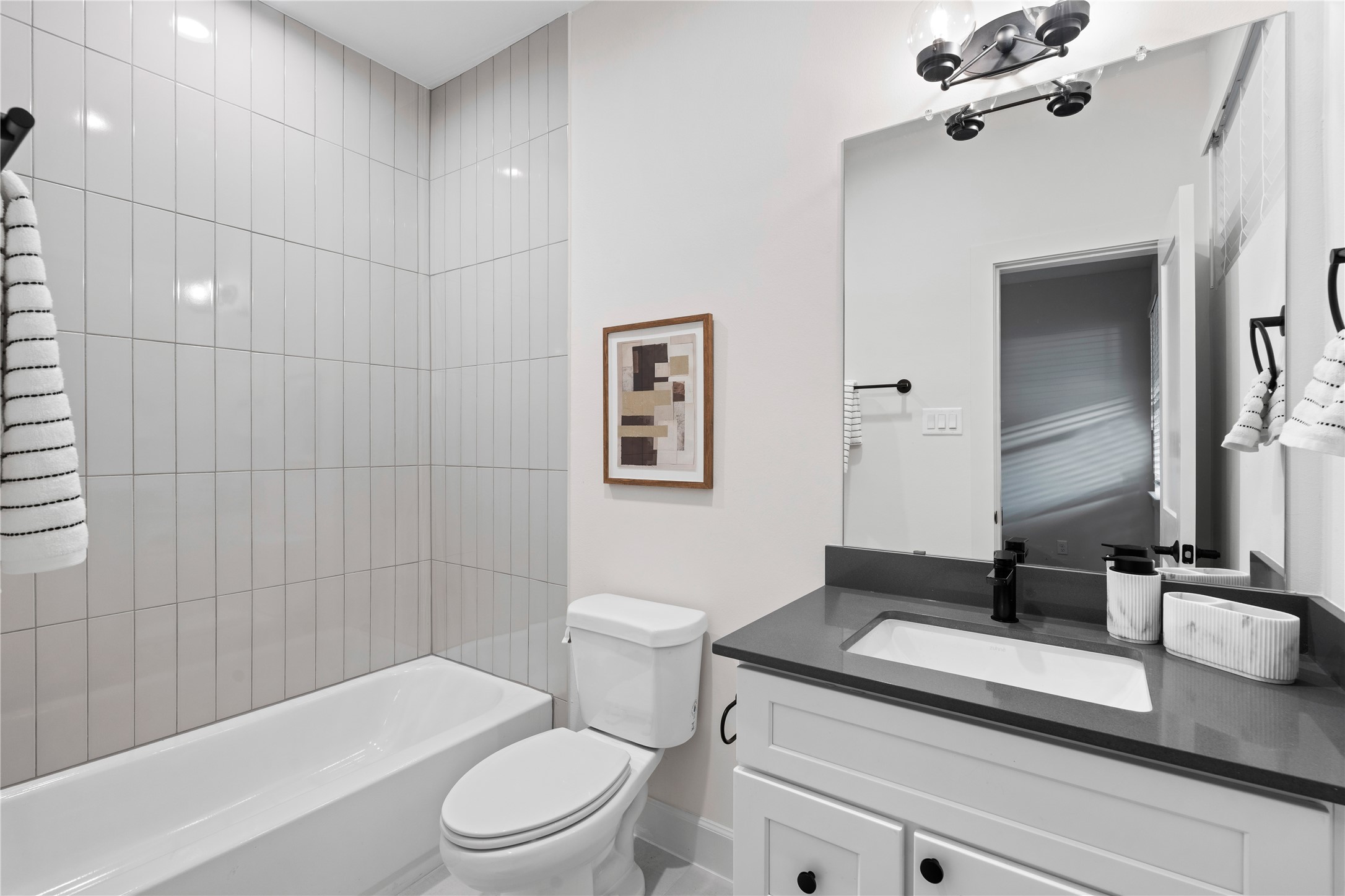 4708 Moving Meadows Houston, TX 77018 - Photo 8 of 40 Every bedroom comes with it's own private full bathroom with a stunning design using designer tile to the ceiling and quartz countertop and matte finishes.