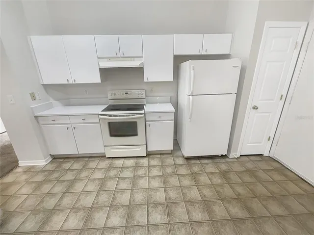 a white refrigerator freezer sitting inside of a kitchen