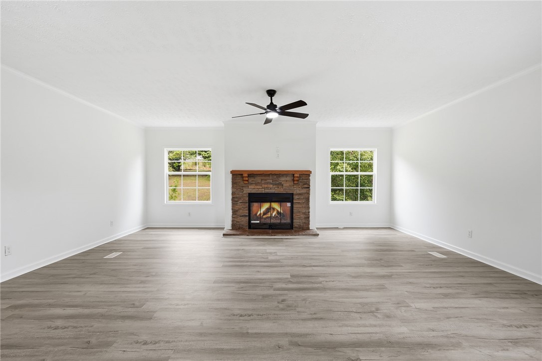 112 Sir Francis Drake Way Liberty, SC 29657 - Photo 15 of 42 This bright living space features a cozy fireplace and inviting flooring, perfect for gatherings.