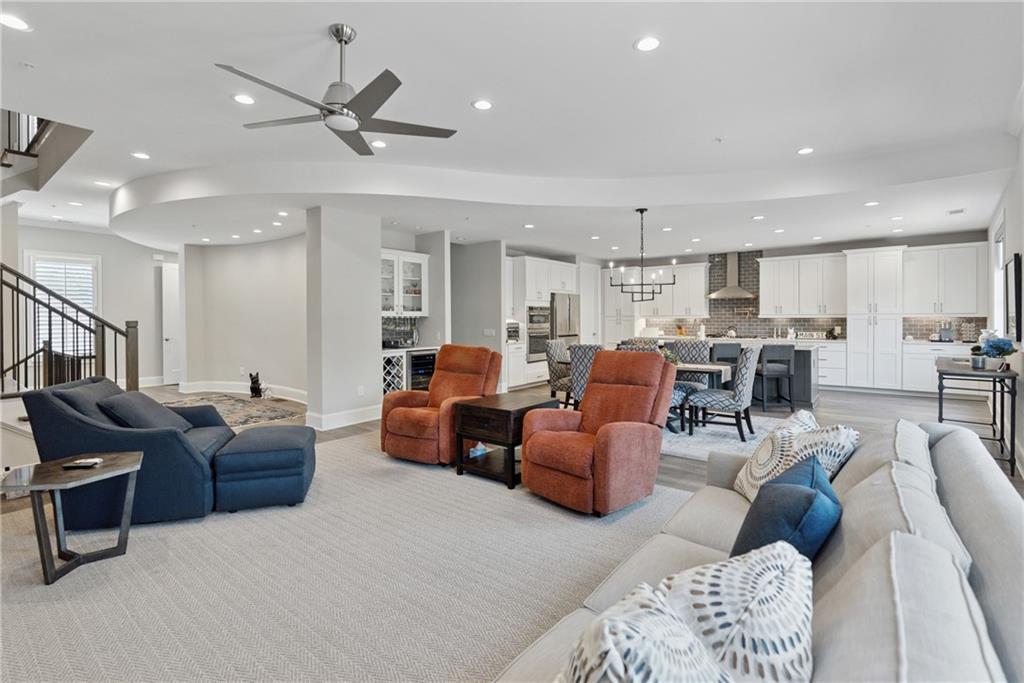 8255 Main Street, Unit 2 Woodstock, GA 30188 - Photo 11 of 46 a living room with furniture kitchen view and a chandelier