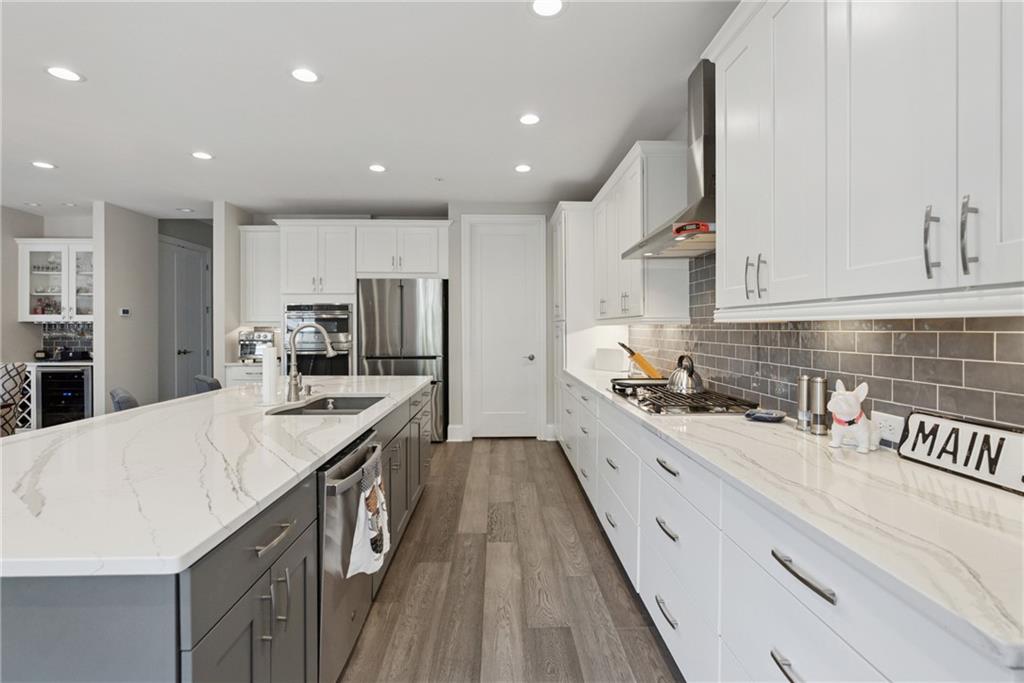 8255 Main Street, Unit 2 Woodstock, GA 30188 - Photo 17 of 46 a kitchen with stainless steel appliances granite countertop a sink a stove and a refrigerator