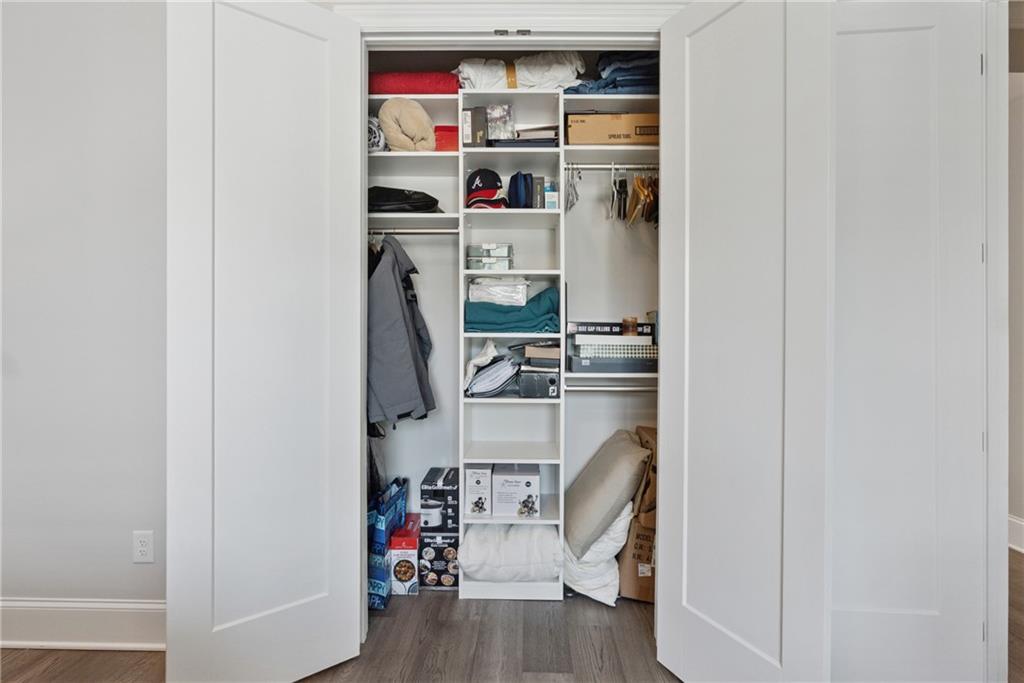 8255 Main Street, Unit 2 Woodstock, GA 30188 - Photo 34 of 46 a view of walk in closet with clothes and shoes