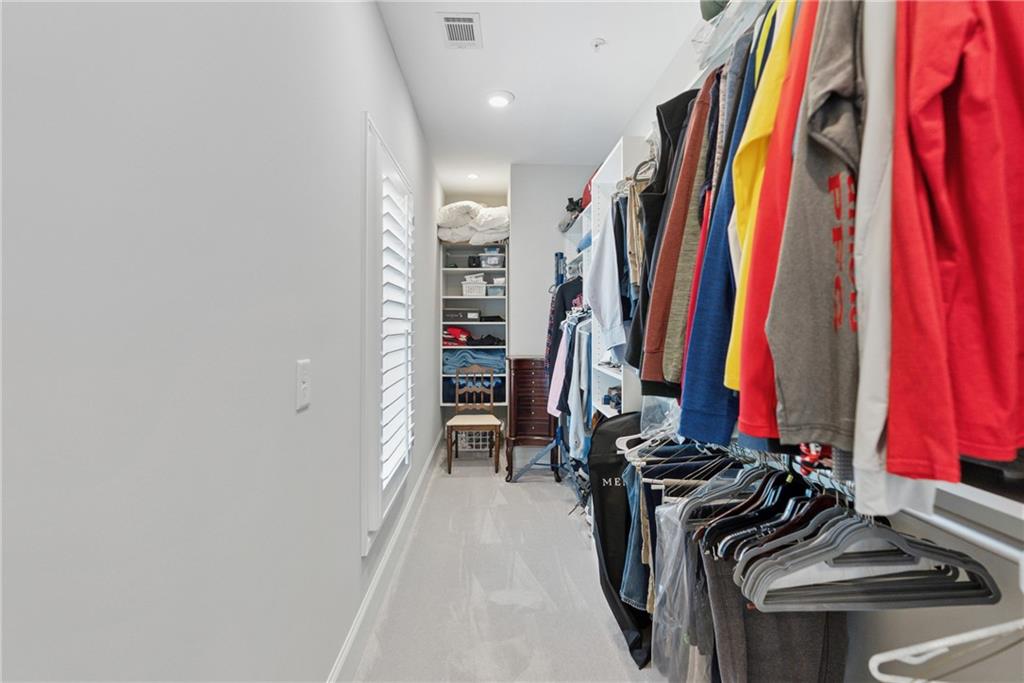 8255 Main Street, Unit 2 Woodstock, GA 30188 - Photo 35 of 46 a view of walk in closet with clothes