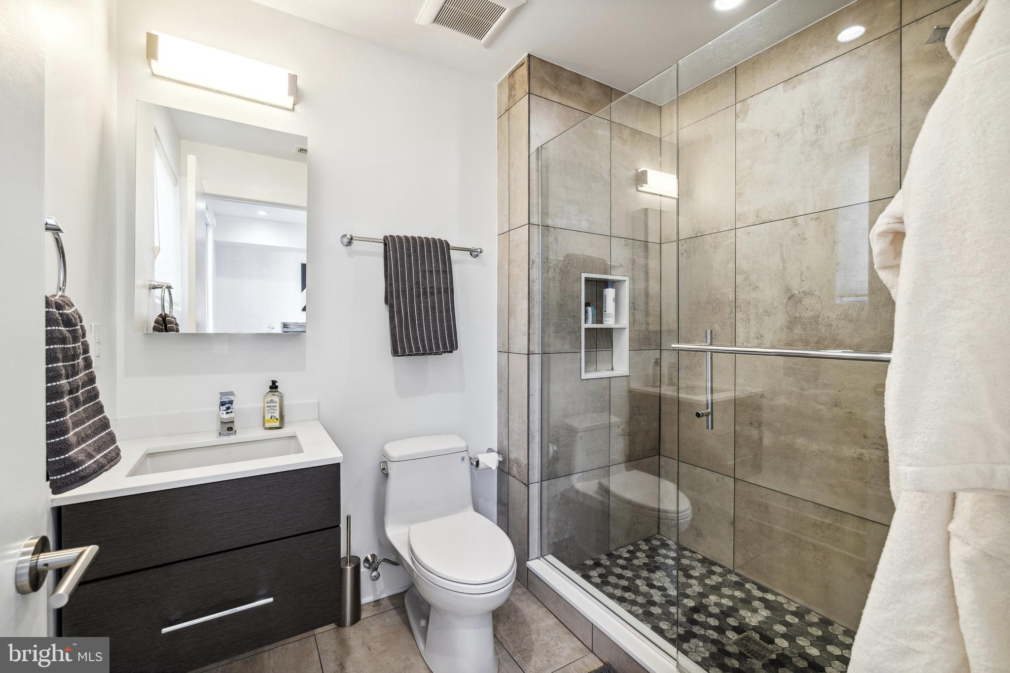48 North 3rd Street, Unit 3 Philadelphia, PA 19106 - Photo 23 of 36 a bathroom with a sink toilet a mirror and shower