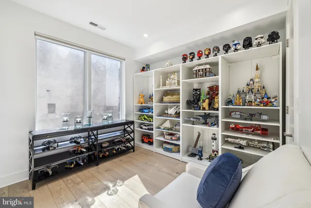 a view of workspace with wooden floor and book shelf