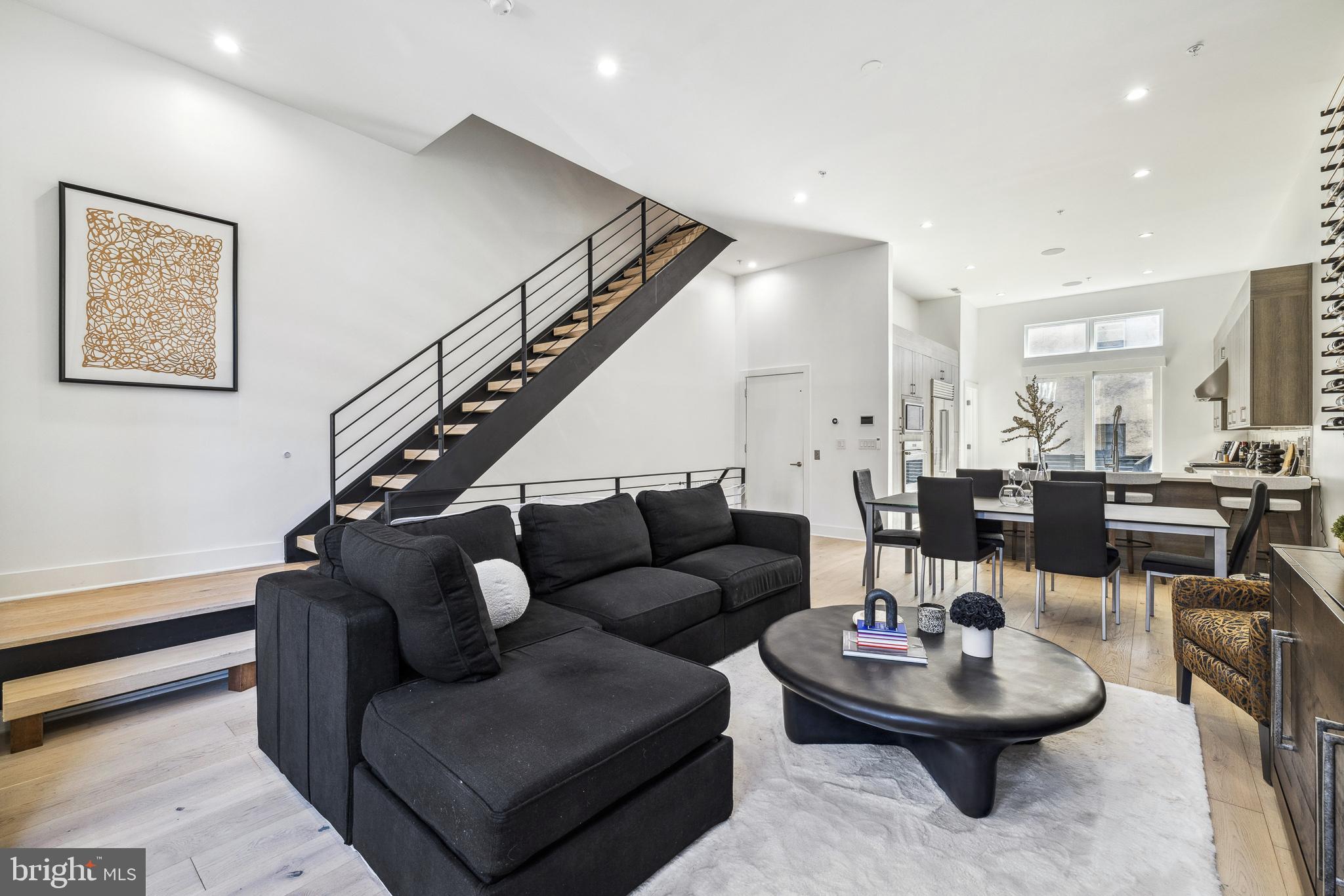 48 North 3rd Street, Unit 3 Philadelphia, PA 19106 - Photo 5 of 36 a living room with couches and a dining table with kitchen view