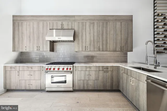 a large white kitchen with a large window