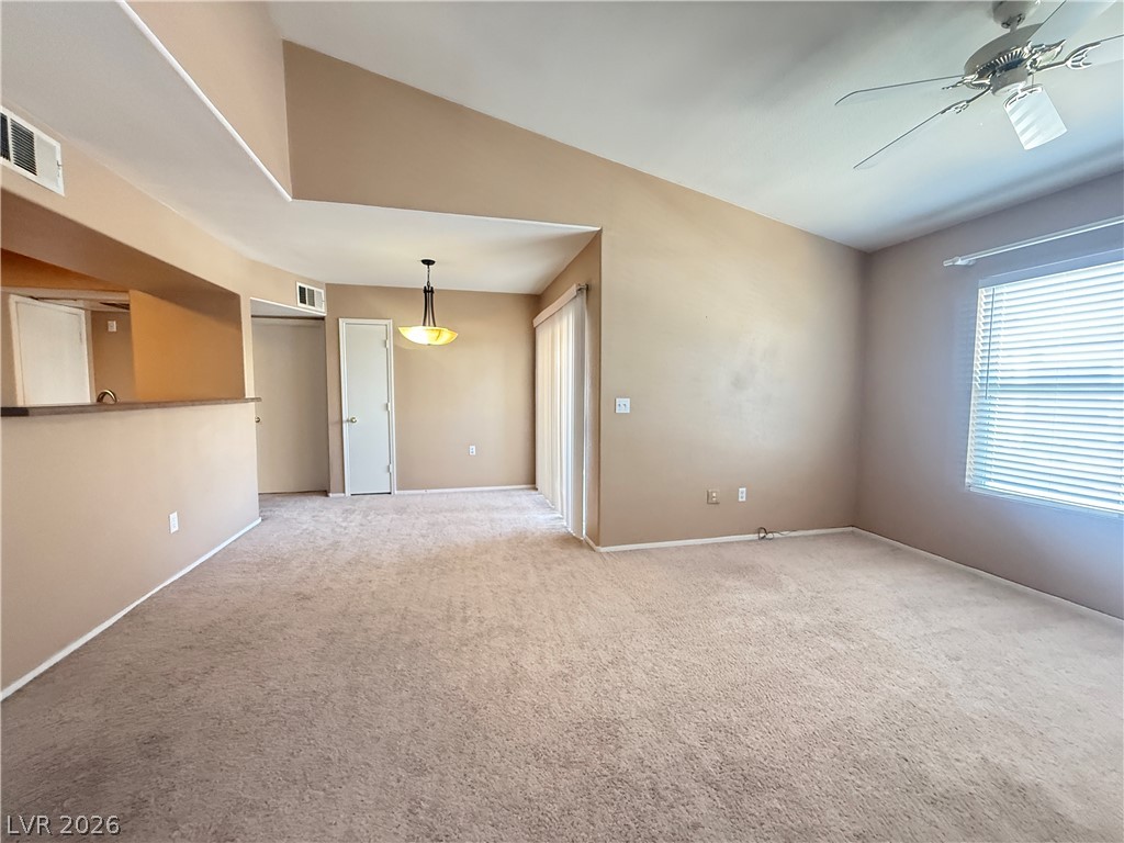 7255 West Sunset Road, Unit 2052 Las Vegas, NV 89113 - Photo 3 of 16 A comfortable living area with soaring vaulted ceilings, plush carpeting, and abundant natural light.