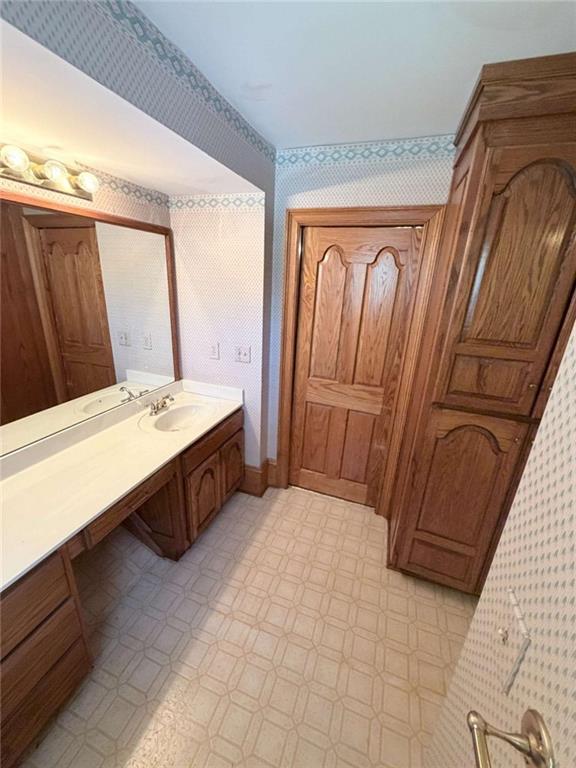 763 McDaniel Mill Road Southwest Conyers, GA 30094 - Photo 44 of 80 a bathroom with a tub a sink and a large mirror