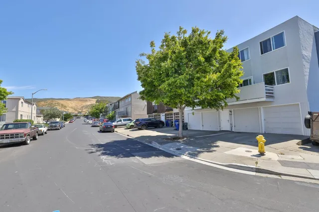 a row of car parked on the side of the road