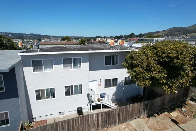 a front view of a house with a yard and mountain view