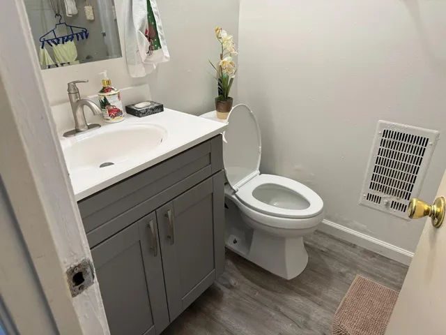 a bathroom with a sink toilet and a mirror