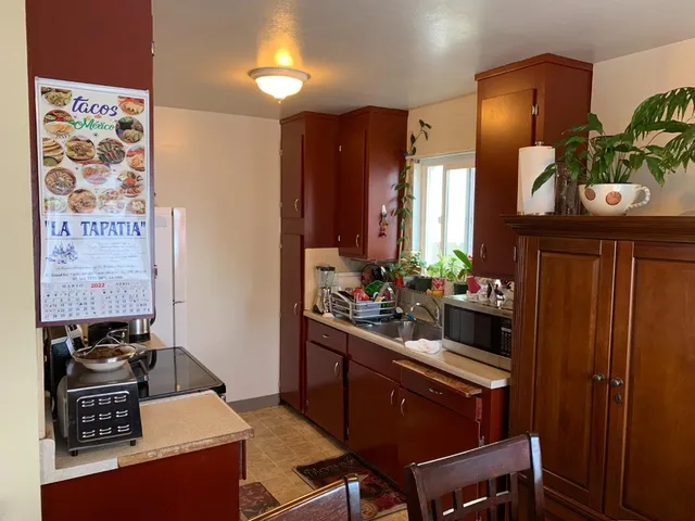 a kitchen with a stove and a refrigerator