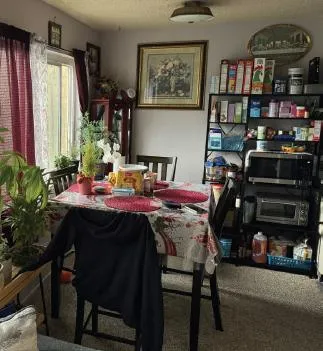 a view of a dining room with furniture and chandelier