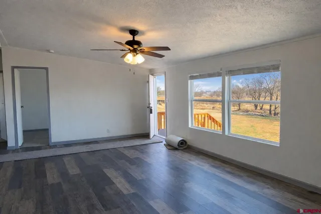 a bathroom with a granite countertop sink a toilet and a large mirror