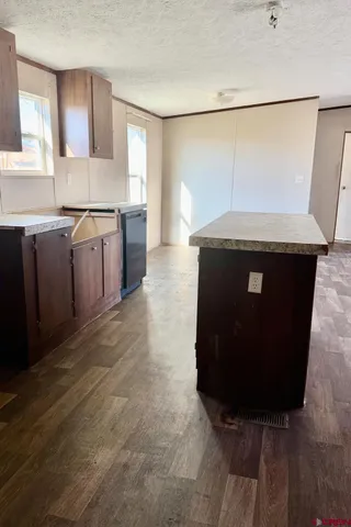 a kitchen with a sink a stove and a refrigerator