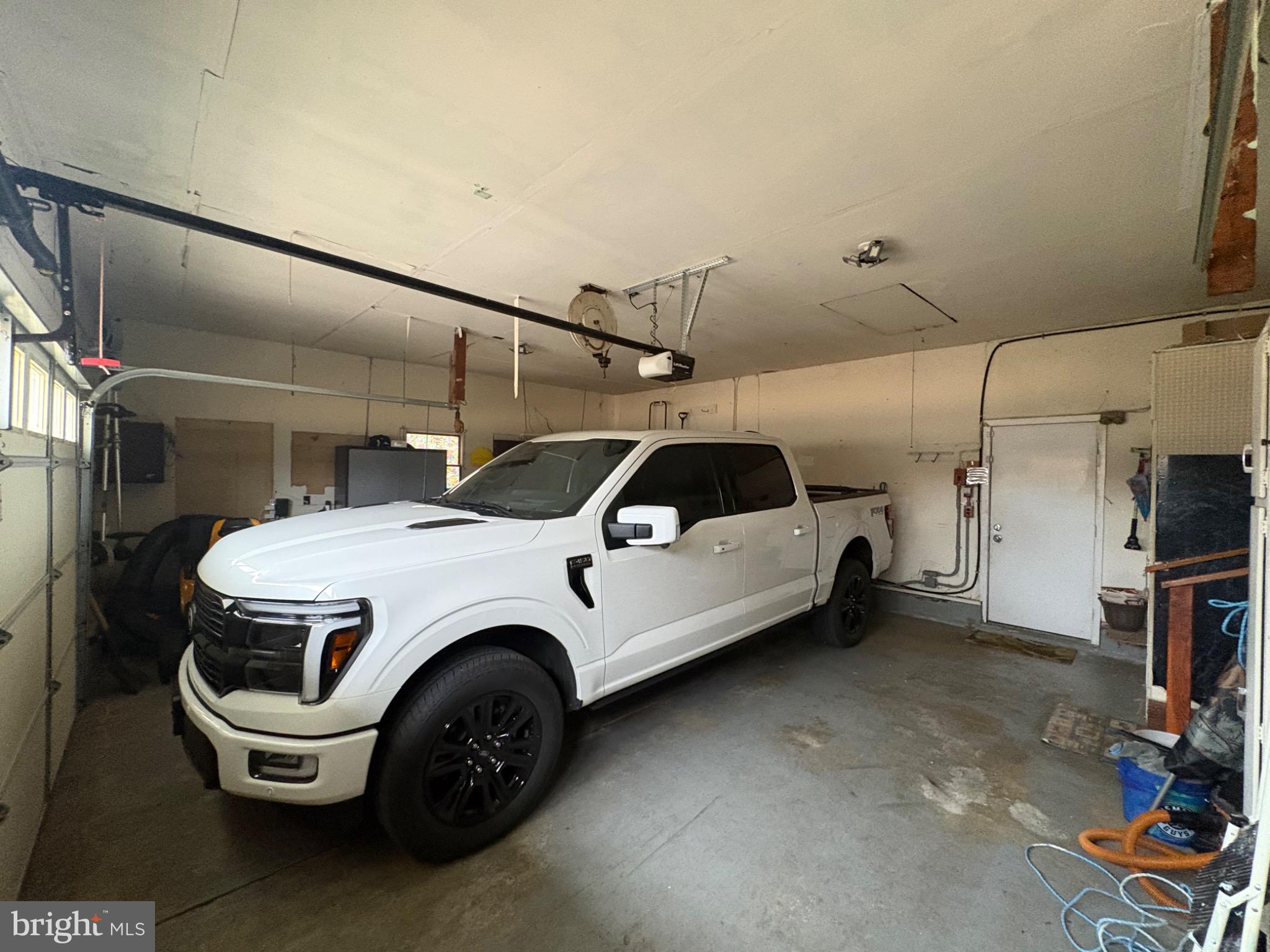 152 Pine Bluff Road Felton, DE 19943 - Photo 14 of 16 Spacious garage with a sleek white truck.