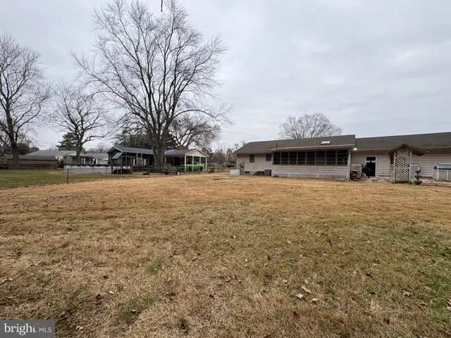 a view of a house with a yard covered with snow in front of house