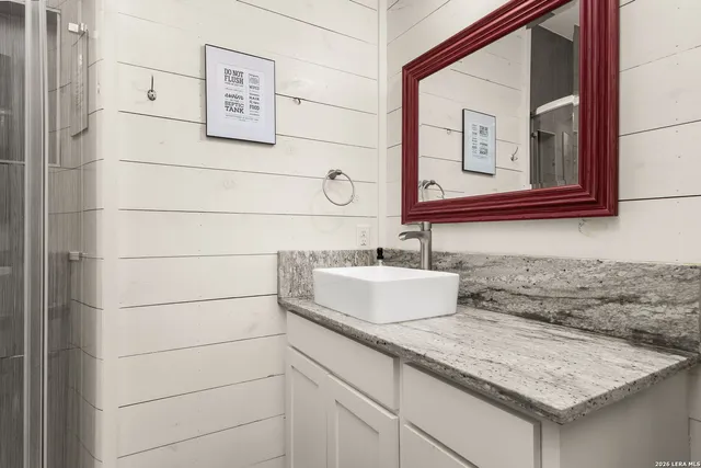 a bedroom with a bed a dresser and chair