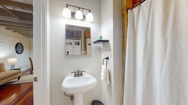a bathroom with a sink a mirror and a toilet