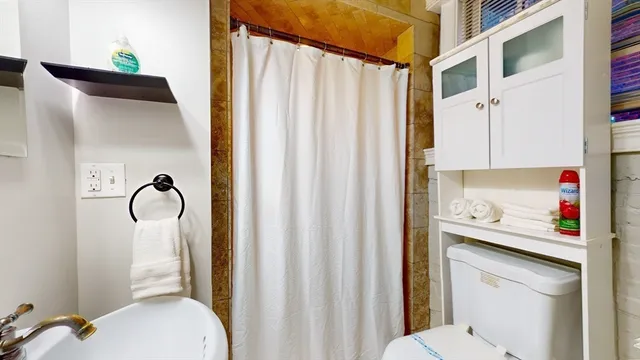 a bathroom with a sink toilet and shower