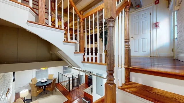 a view of balcony with two chairs and a potted plant