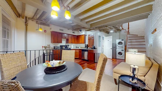 a living room with dining room and a table