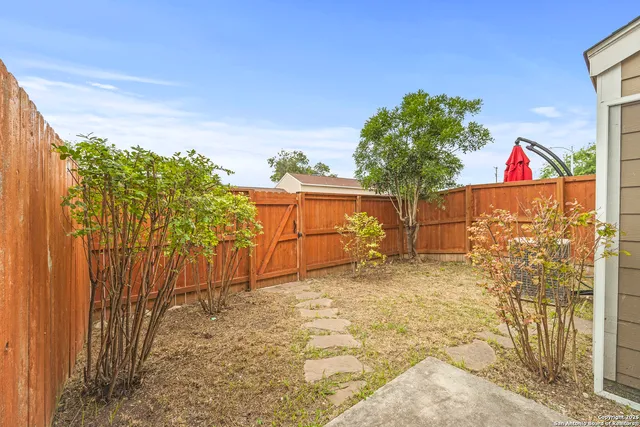 a view of a house with wooden fence