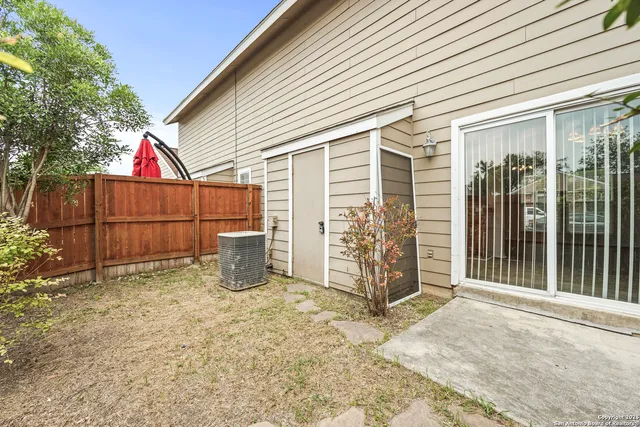 a view of a backyard with wooden fence