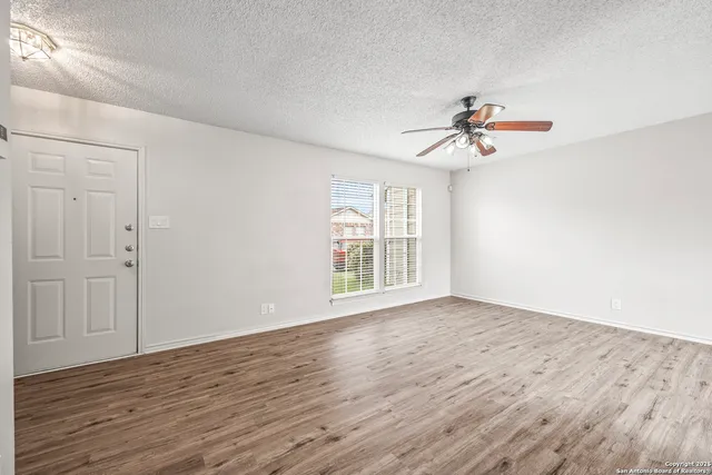 wooden floor in an empty room with a window