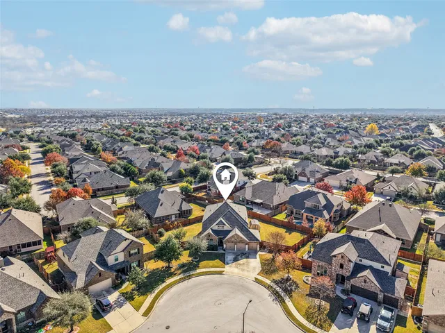an aerial view of residential building with yard