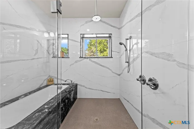 a bathroom with a bathtub and a shower