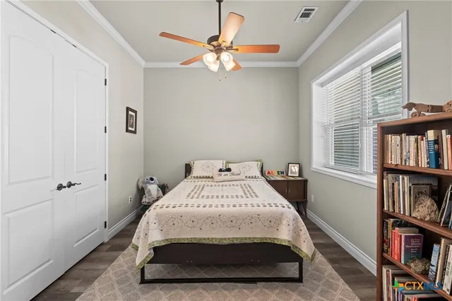 a bedroom with a bed and a book shelf