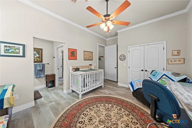 a bedroom with a bed and a chandelier