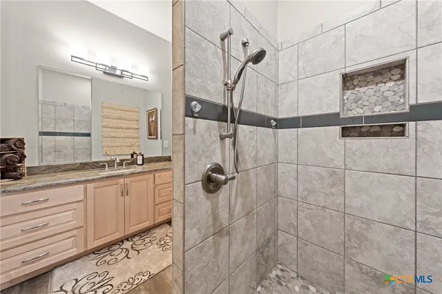 a bathroom with a shower and a sink