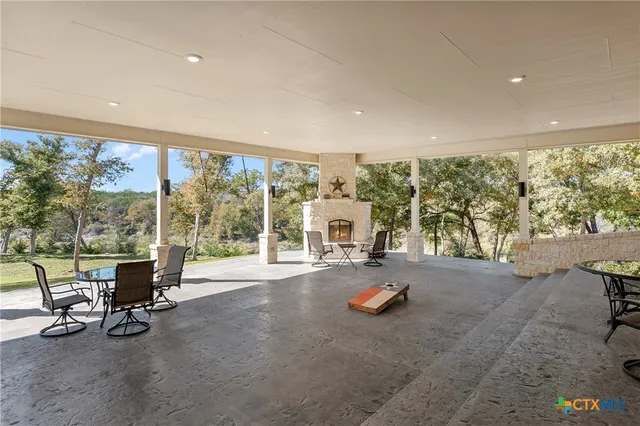 a view of a room with gym equipment and large windows