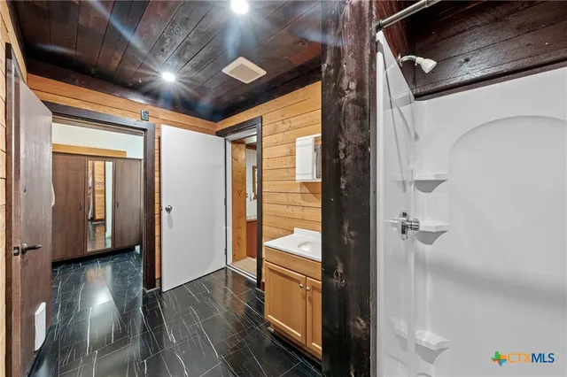 a view of a hallway with wooden floor and stairs