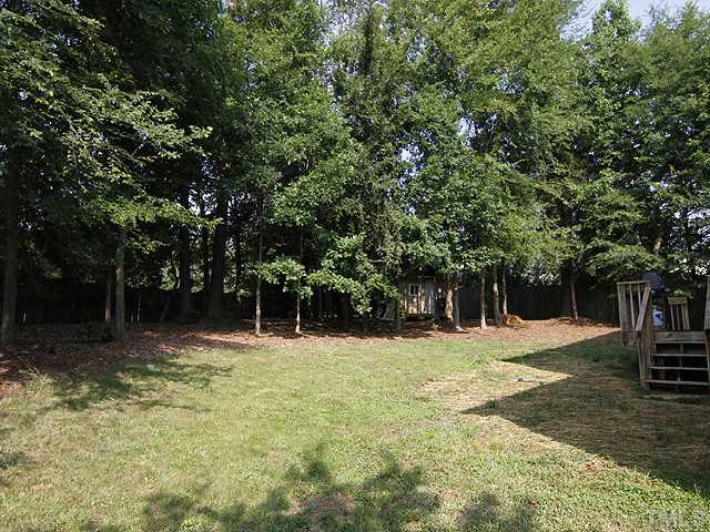 2504 Bulmer Terrace Raleigh, NC 27615 - Photo 11 of 12 a backyard of a house with trees and houses