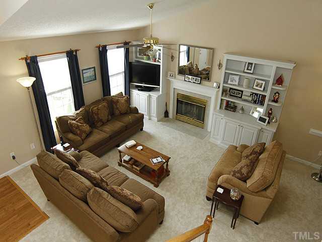 2504 Bulmer Terrace Raleigh, NC 27615 - Photo 2 of 12 a living room with furniture a flat screen tv and a fireplace